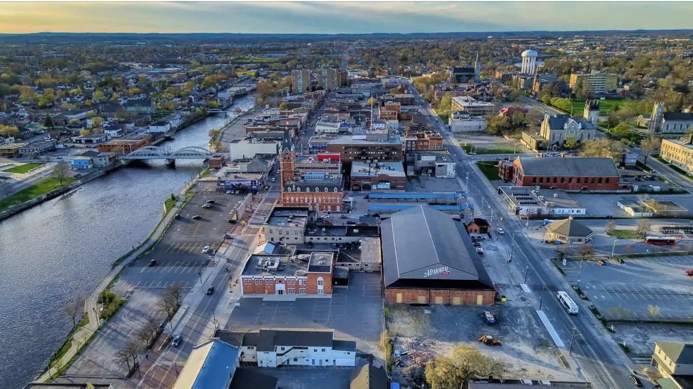 High-altitude aerial photograph of Peterborough, Ontario showing the city centre, Otonabee River, and residential areas where Velora Water Systems installs luxury water filtration systems