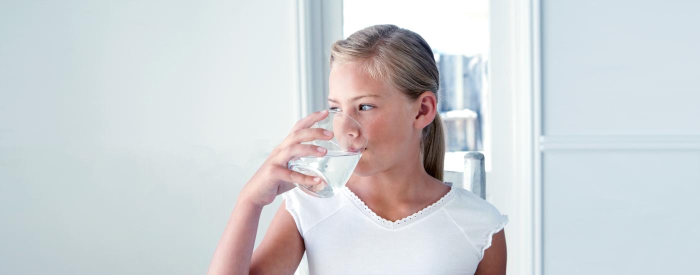 A child enjoying a glass of water